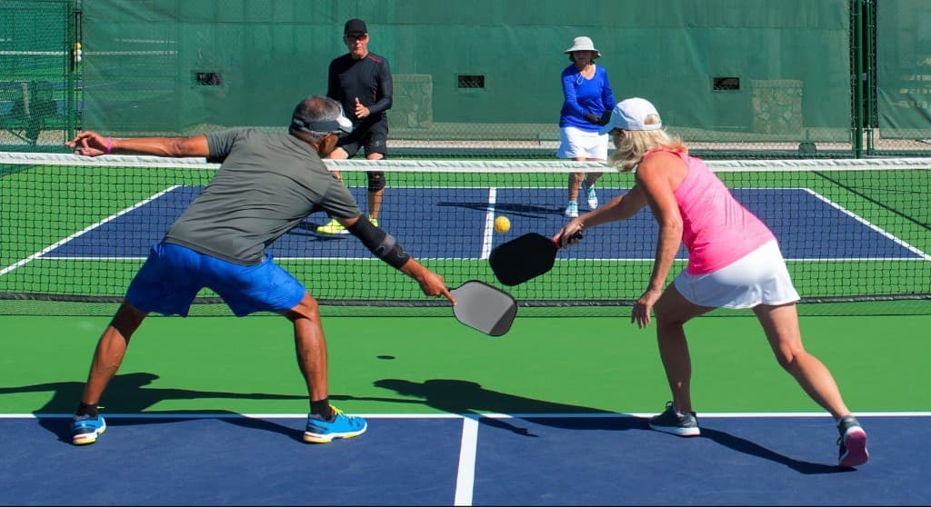 People playing pickleball on a court — tournaments, coaching, clinics